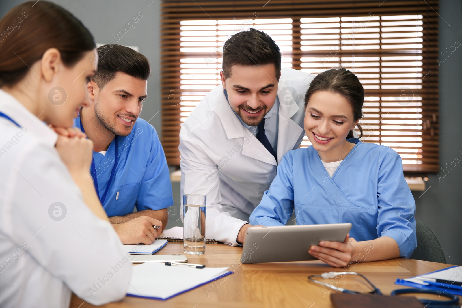 Photo of Team of professional doctors having meeting in office