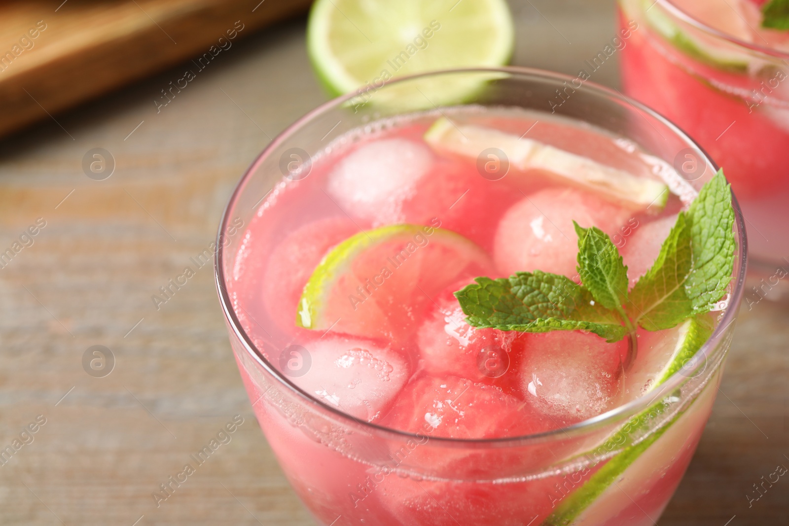 Photo of Tasty refreshing watermelon drink on wooden table, closeup