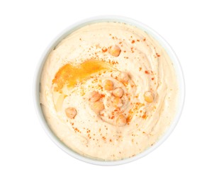 Photo of Tasty hummus with garnish in bowl isolated on white, top view