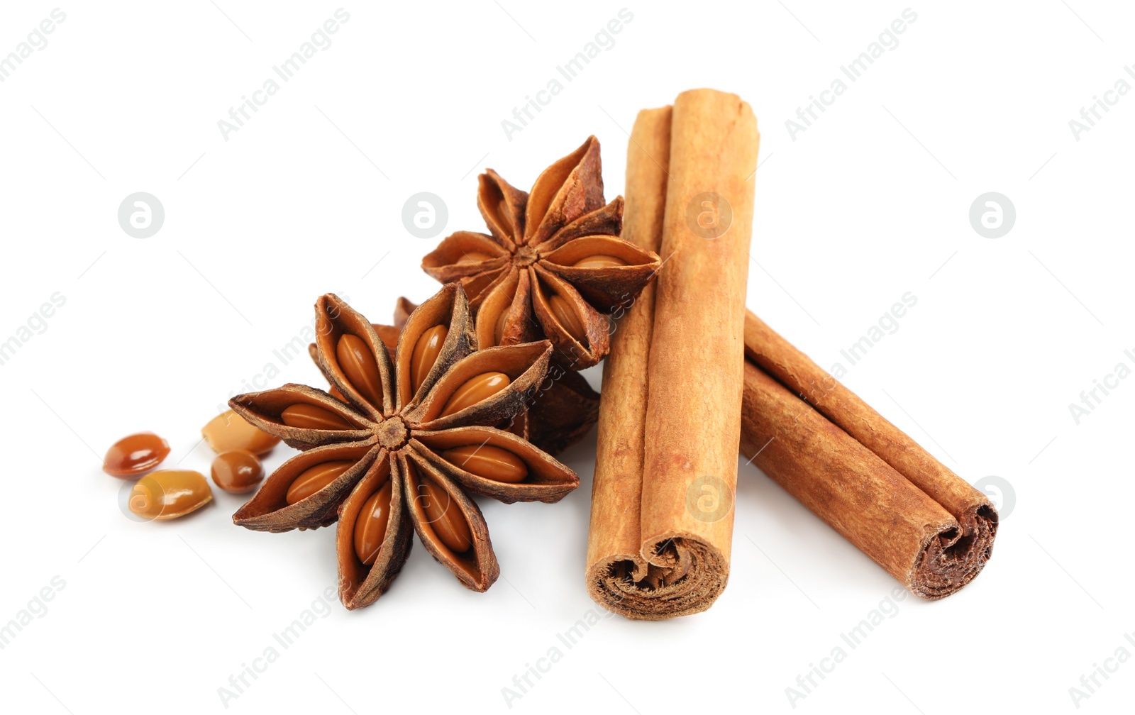 Photo of Dry anise stars and cinnamon sticks on white background