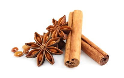 Photo of Dry anise stars and cinnamon sticks on white background