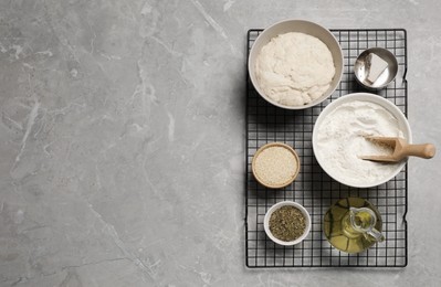Photo of Cooking grissini. Different ingredients on grey marble table, flat lay. Space for text
