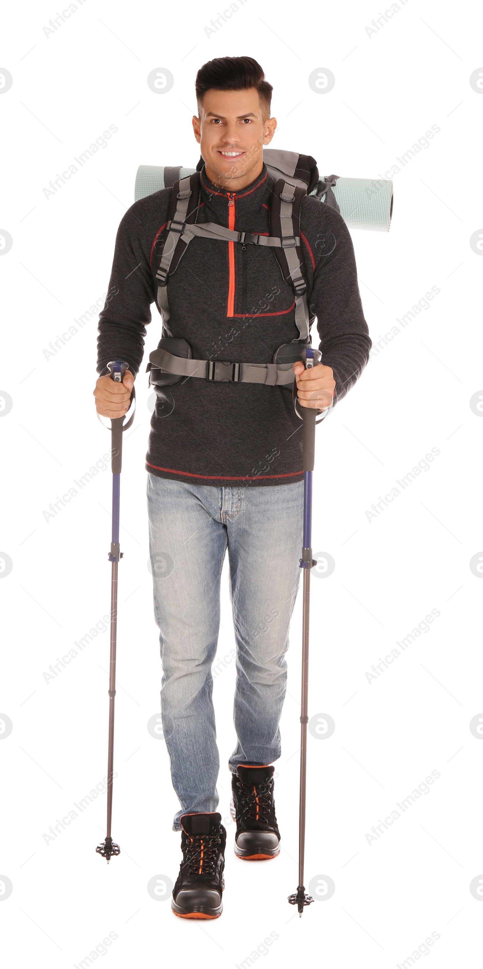 Photo of Male hiker with backpack and trekking poles on white background