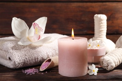 Photo of Composition with spa supplies and flowers on wooden table