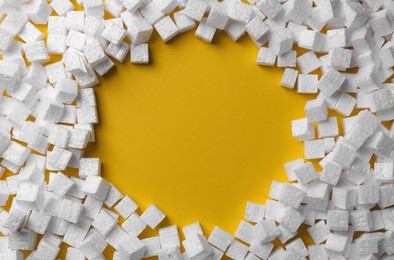 Frame made of styrofoam cubes on yellow background, flat lay. Space for text