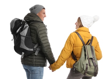 Photo of Couple with backpacks on white background, back view. Winter travel