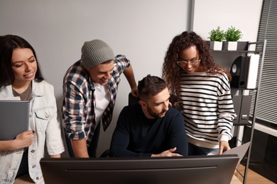 Photo of Team of employees working together in office. Startup project