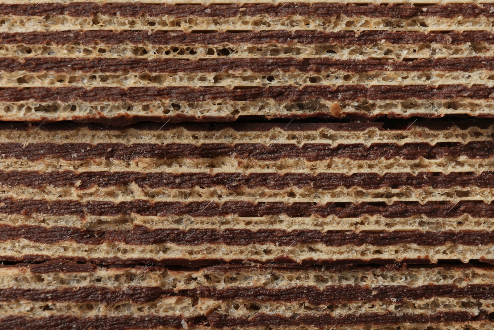 Photo of Closeup view of tasty wafer sticks as background. Sweet food