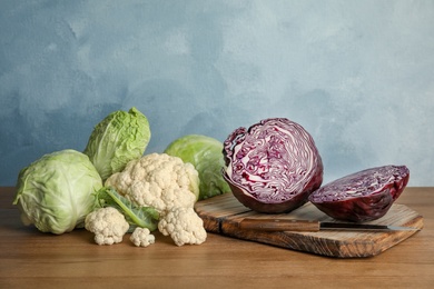 Different sorts of cabbage on wooden table