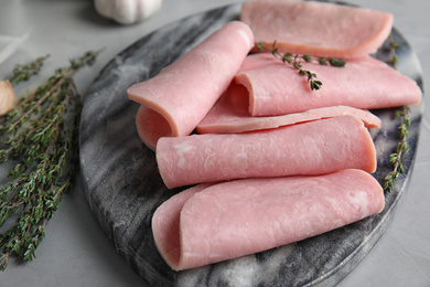 Photo of Tasty ham on light grey table, closeup