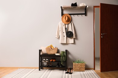 Photo of Hallway interior with stylish furniture, clothes and accessories