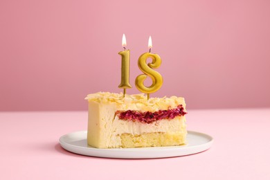 Photo of Coming of age party - 18th birthday. Delicious cake with number shaped candles on pink background