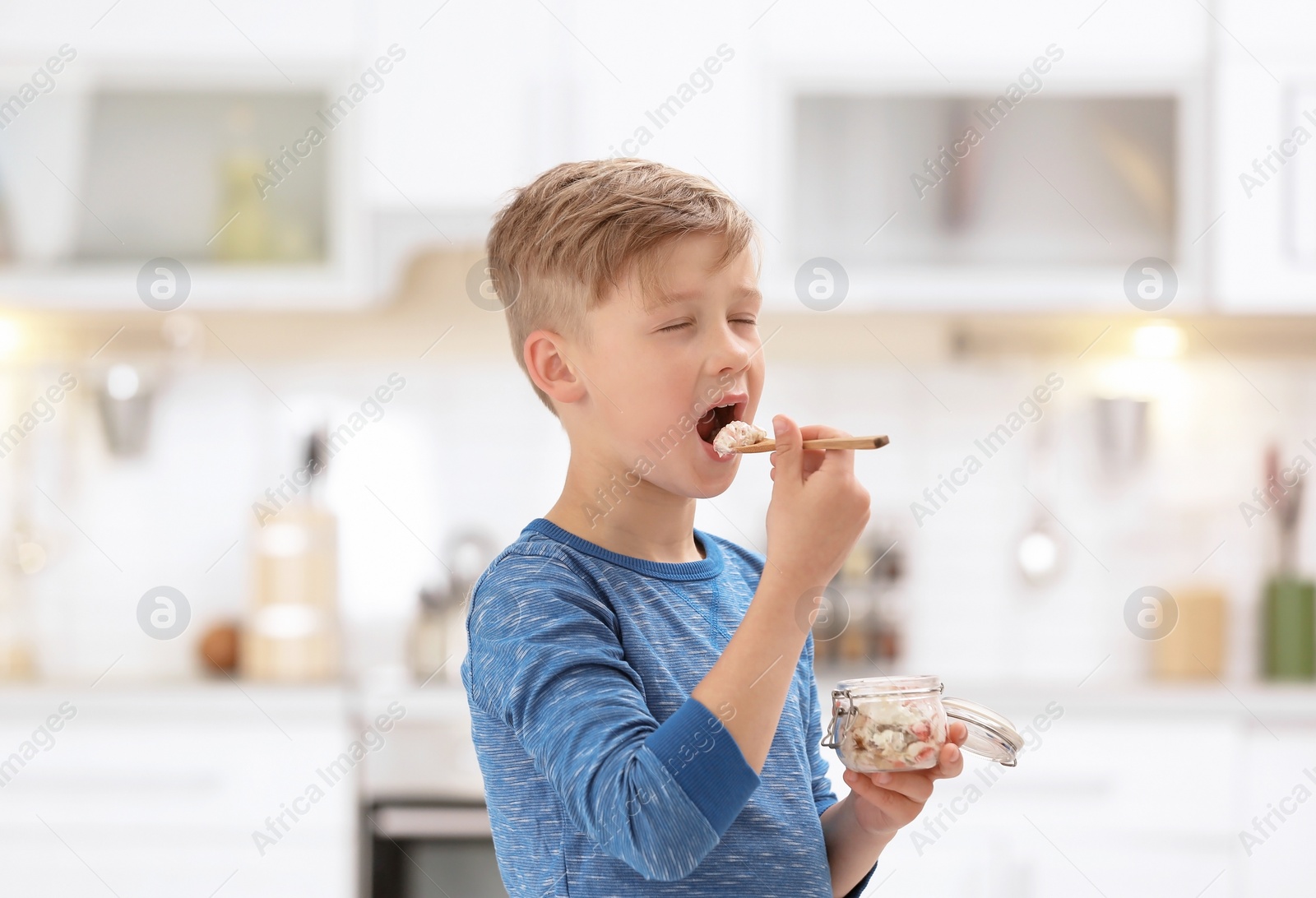 Photo of Little boy with yogurt on blurred background