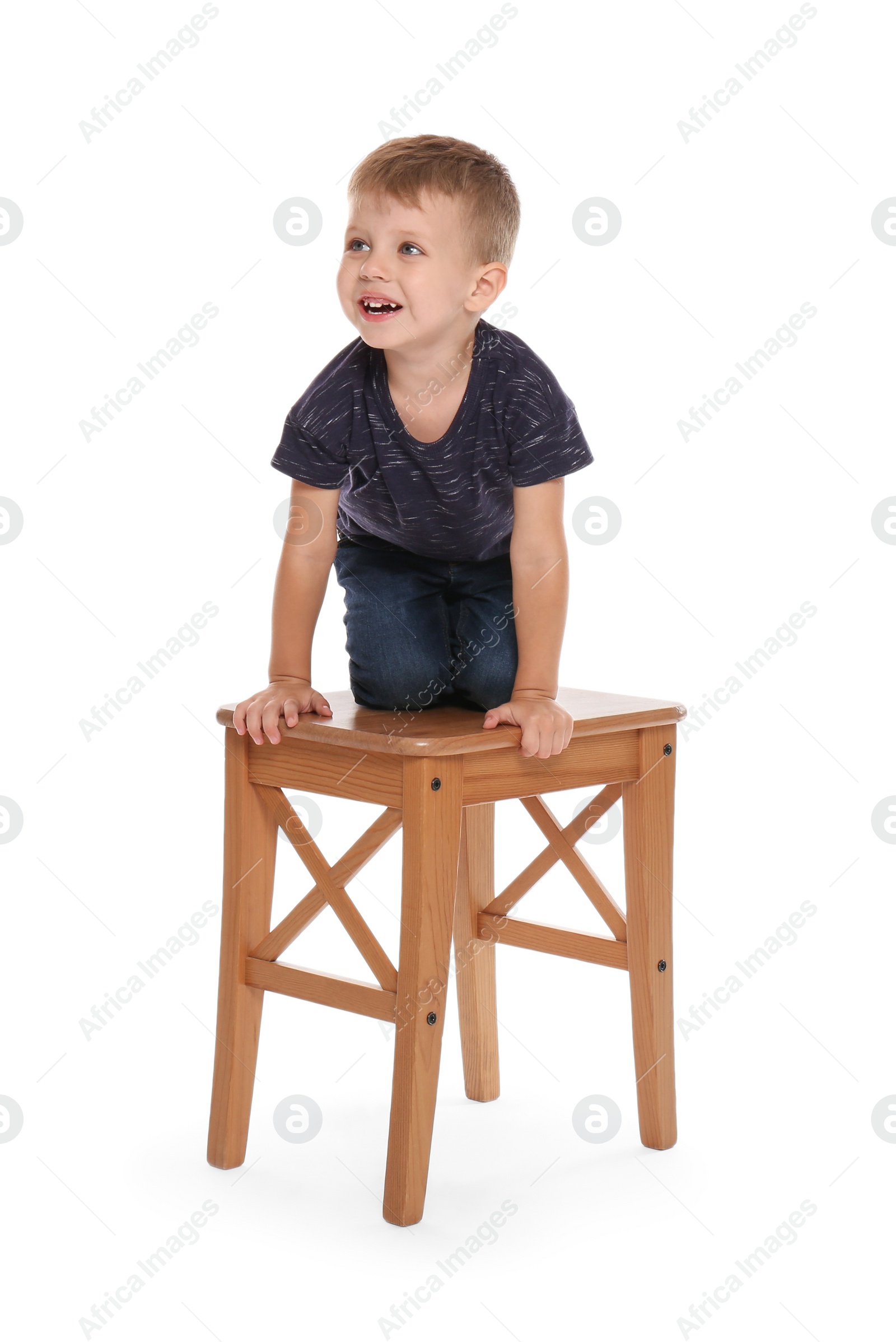Photo of Little boy climbing up stool on white background. Danger at home