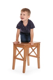 Little boy climbing up stool on white background. Danger at home