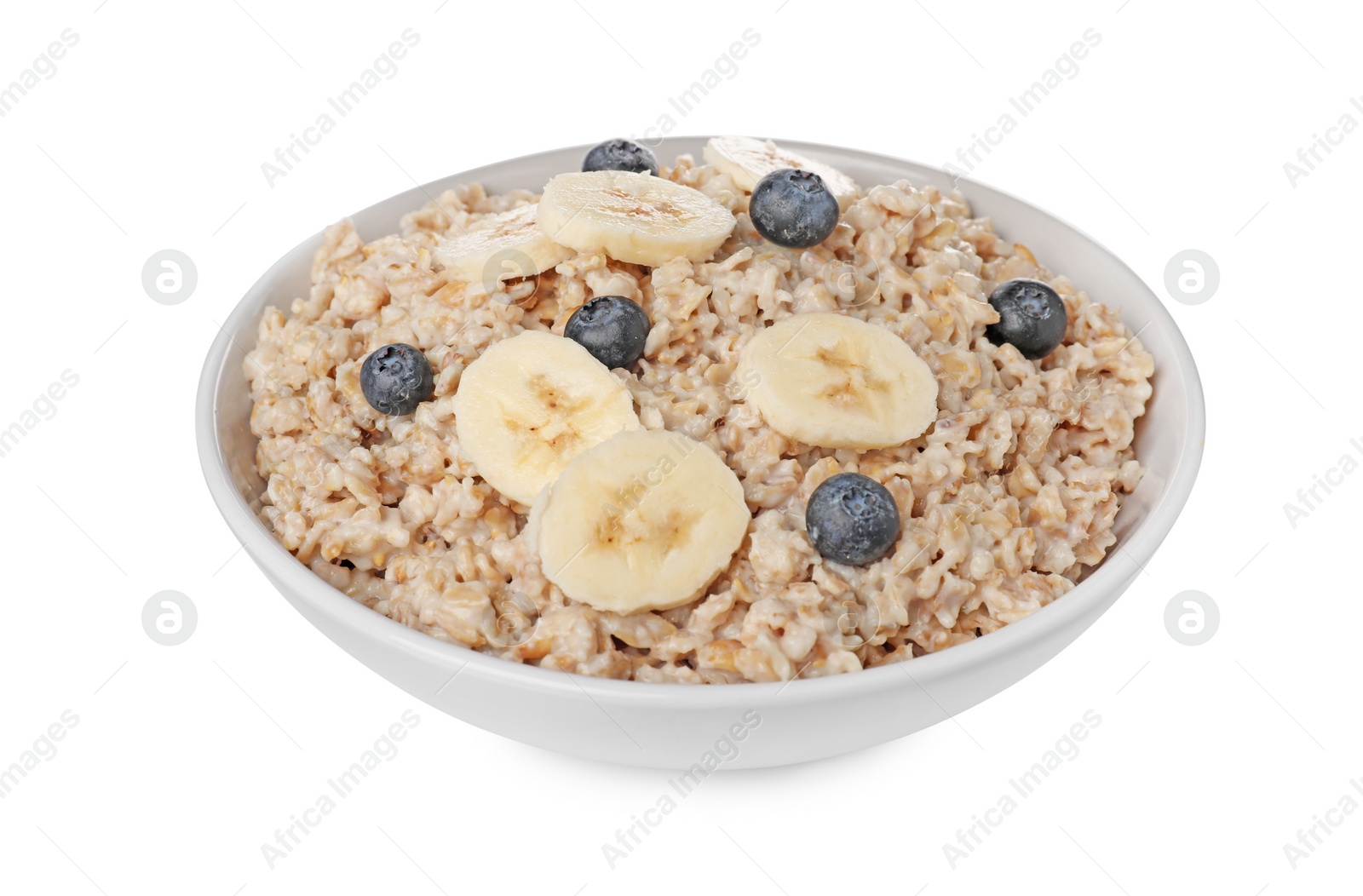 Photo of Tasty boiled oatmeal with blueberries and banana in bowl isolated on white