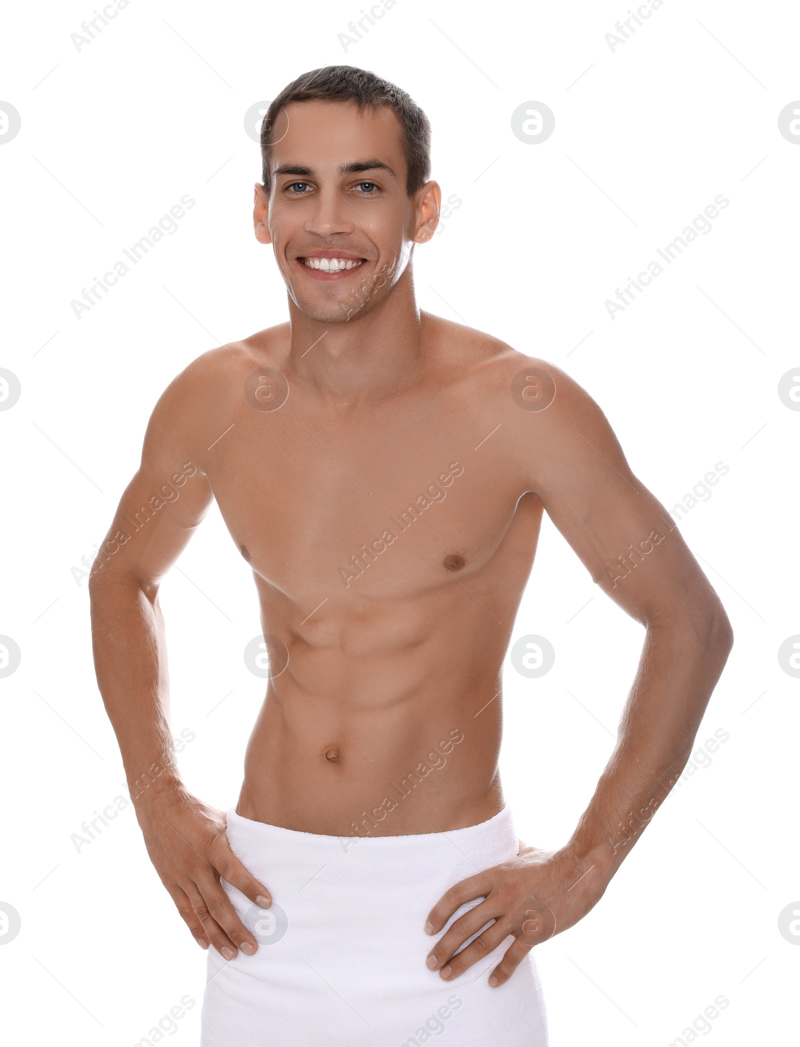 Photo of Handsome shirtless man with slim body and towel wrapped around his hips isolated on white