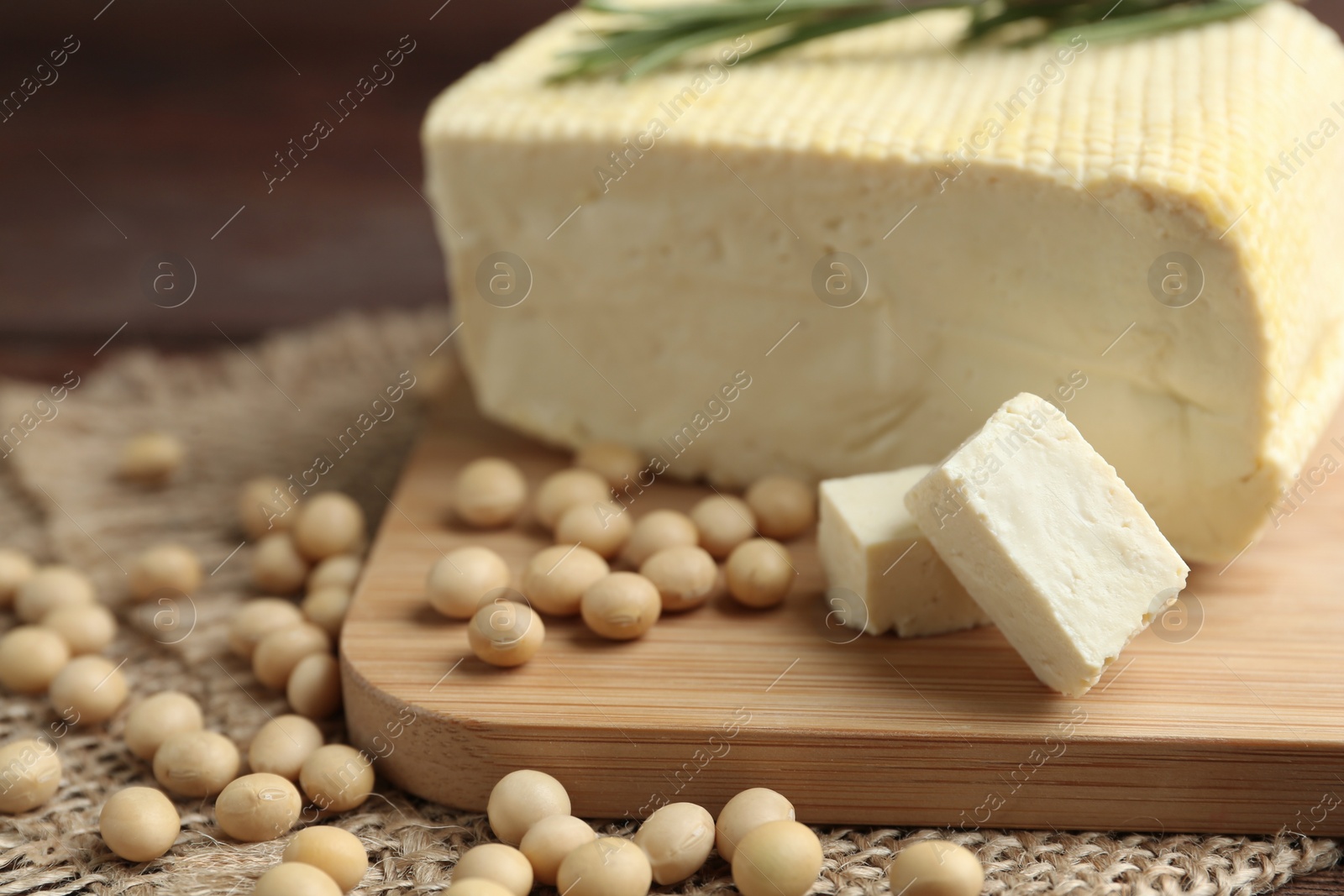 Photo of Pieces of delicious tofu and soy on table, closeup