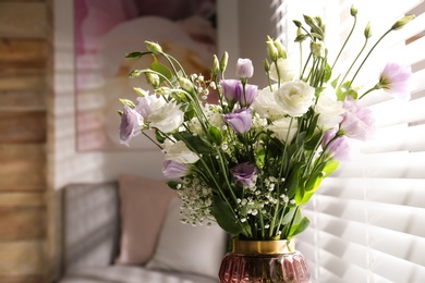 Photo of Bouquet of beautiful Eustoma flowers in room, closeup