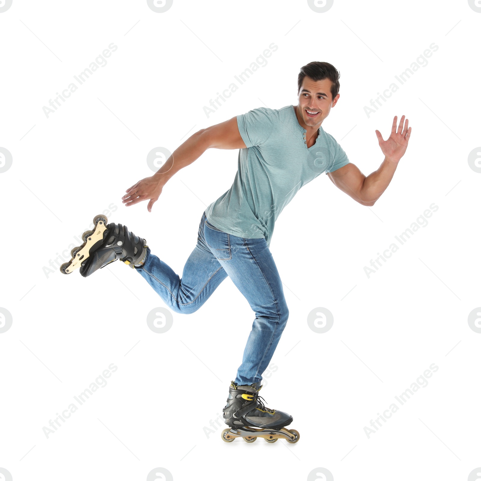 Photo of Handsome young man with inline roller skates on white background