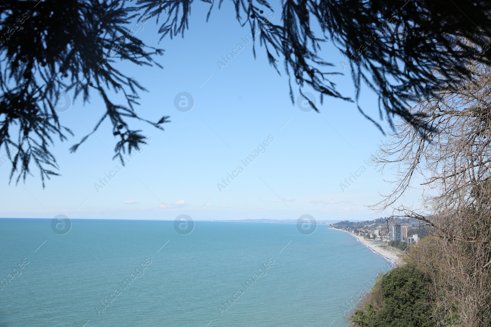 Photo of Picturesque view of beautiful sea and distant city on sunny day