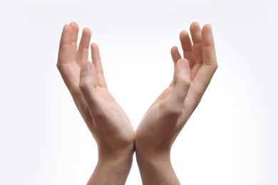 Man holding something in hands on white background, closeup