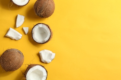 Photo of Flat lay composition with coconuts on color background. Space for text