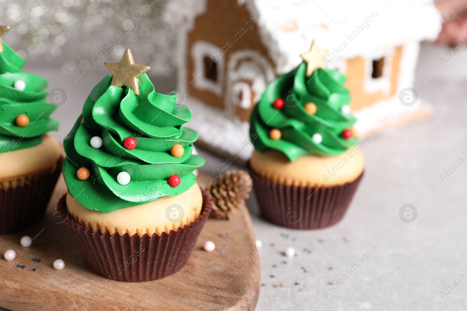 Photo of Christmas tree shaped cupcakes on light grey table