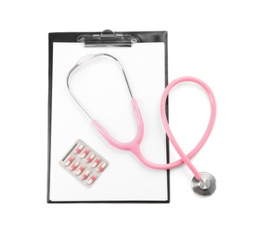 Photo of Stethoscope, pills and clipboard isolated on white, top view. Medical tool