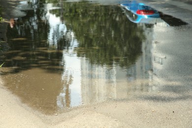 Asphalt with puddle after rain on sunny day