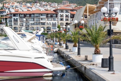 Photo of Beautiful view of city pier with moored boats on sunny day