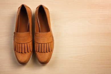 Pair of female shoes on wooden background