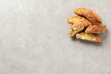 Photo of Traditional Italian almond biscuits (Cantucci) on light table, flat lay. Space for text