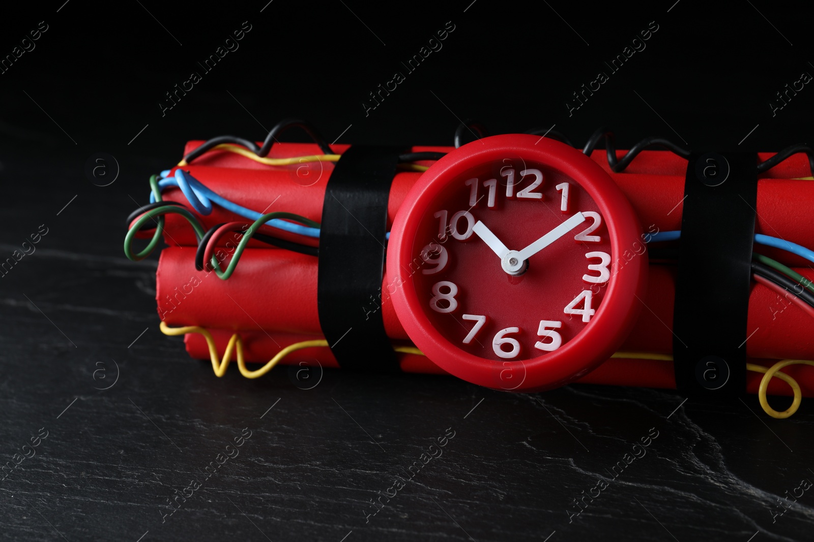 Photo of Explosive dynamite time bomb on black background