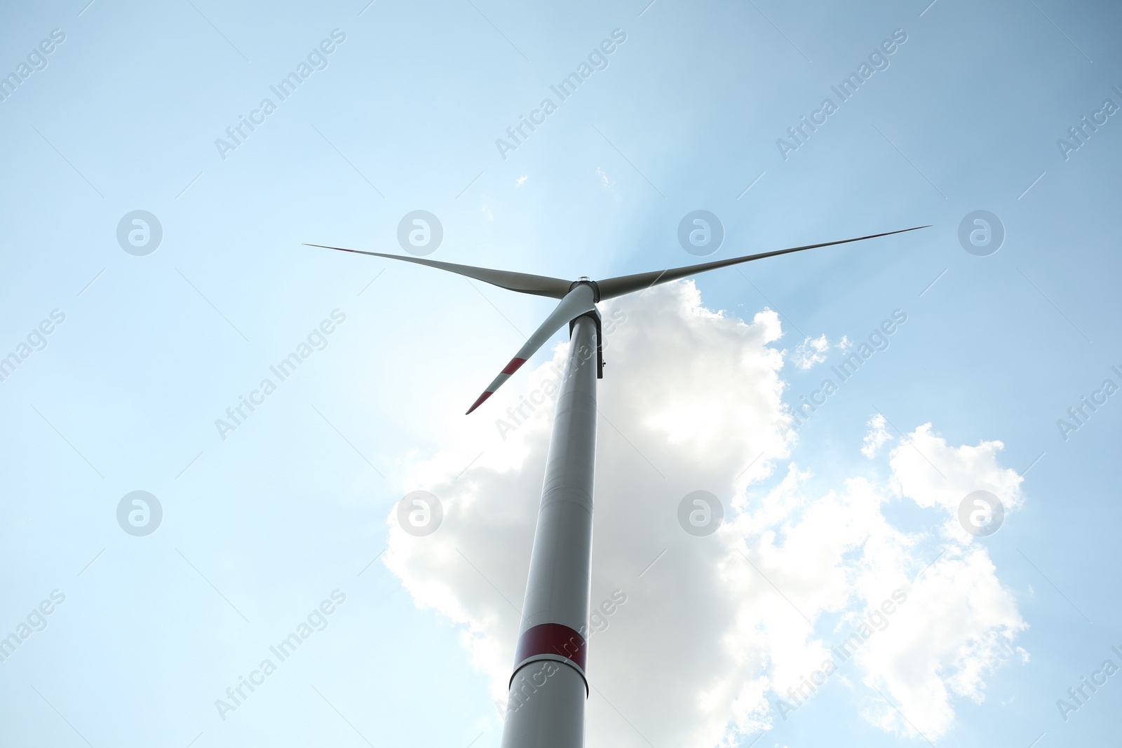 Photo of Modern wind turbine against blue sky, low angle view. Energy efficiency