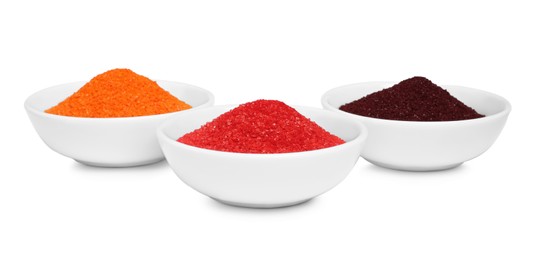 Photo of Bowls with food coloring on white background