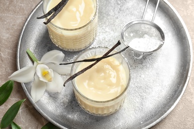 Vanilla pudding, sticks and flower on tray