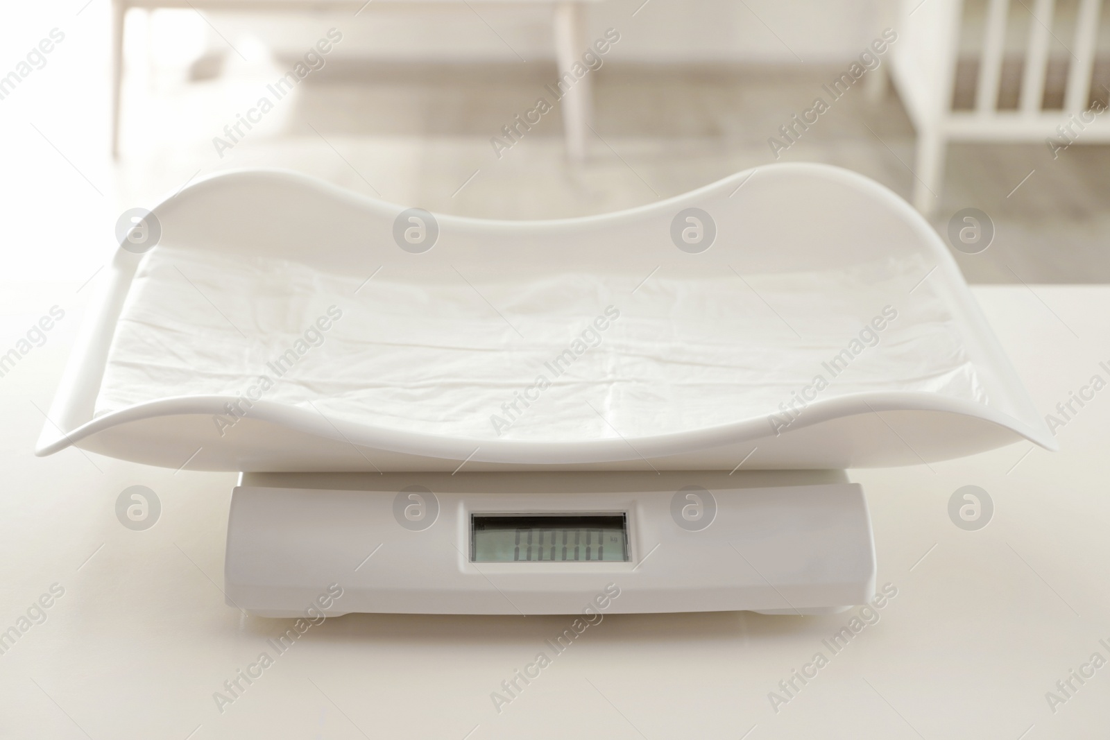 Photo of Modern digital baby scales on table in room