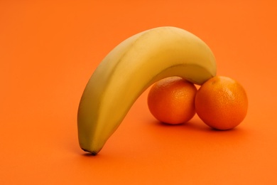 Photo of Fruits symbolizing male sexual organ on orange background. Potency problem