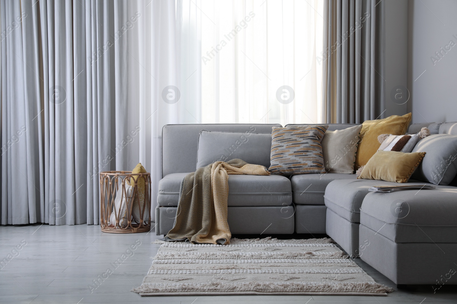 Photo of Living room interior with large grey sofa