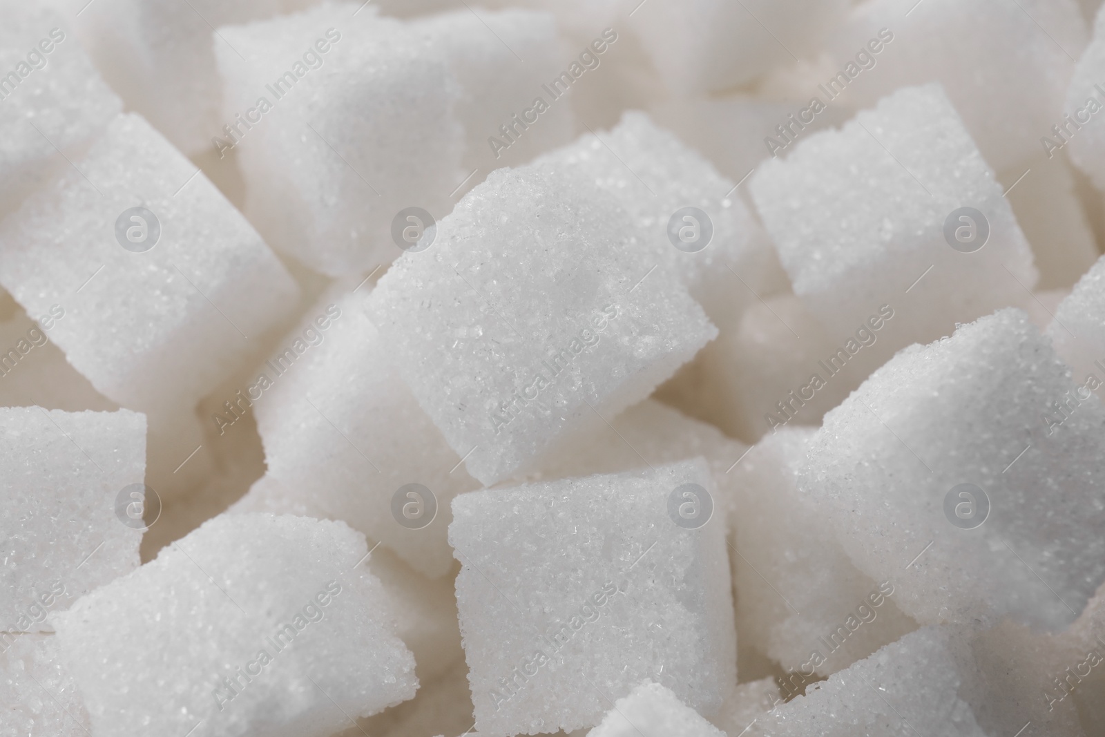 Photo of White sugar cubes as background, closeup view