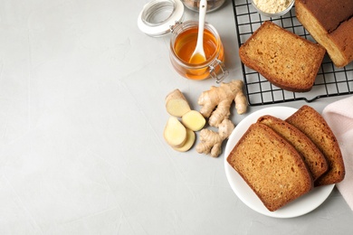 Photo of Fresh gingerbread cake slices and ingredients on light table, flat lay. Space for text