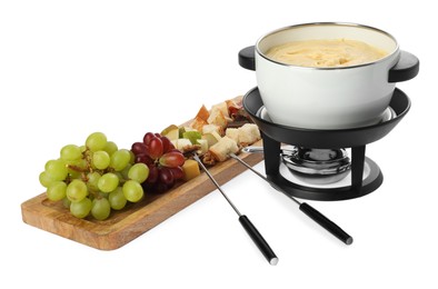 Photo of Fondue with tasty melted cheese, forks and different snacks isolated on white