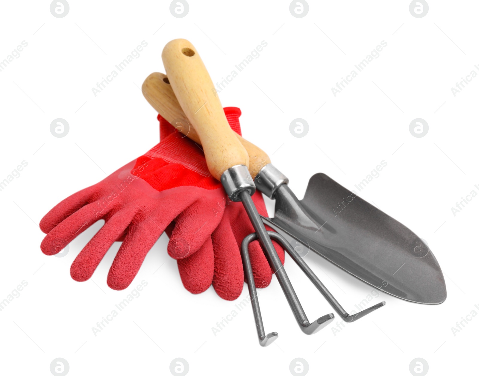 Photo of Gardening gloves, trowel and rake isolated on white