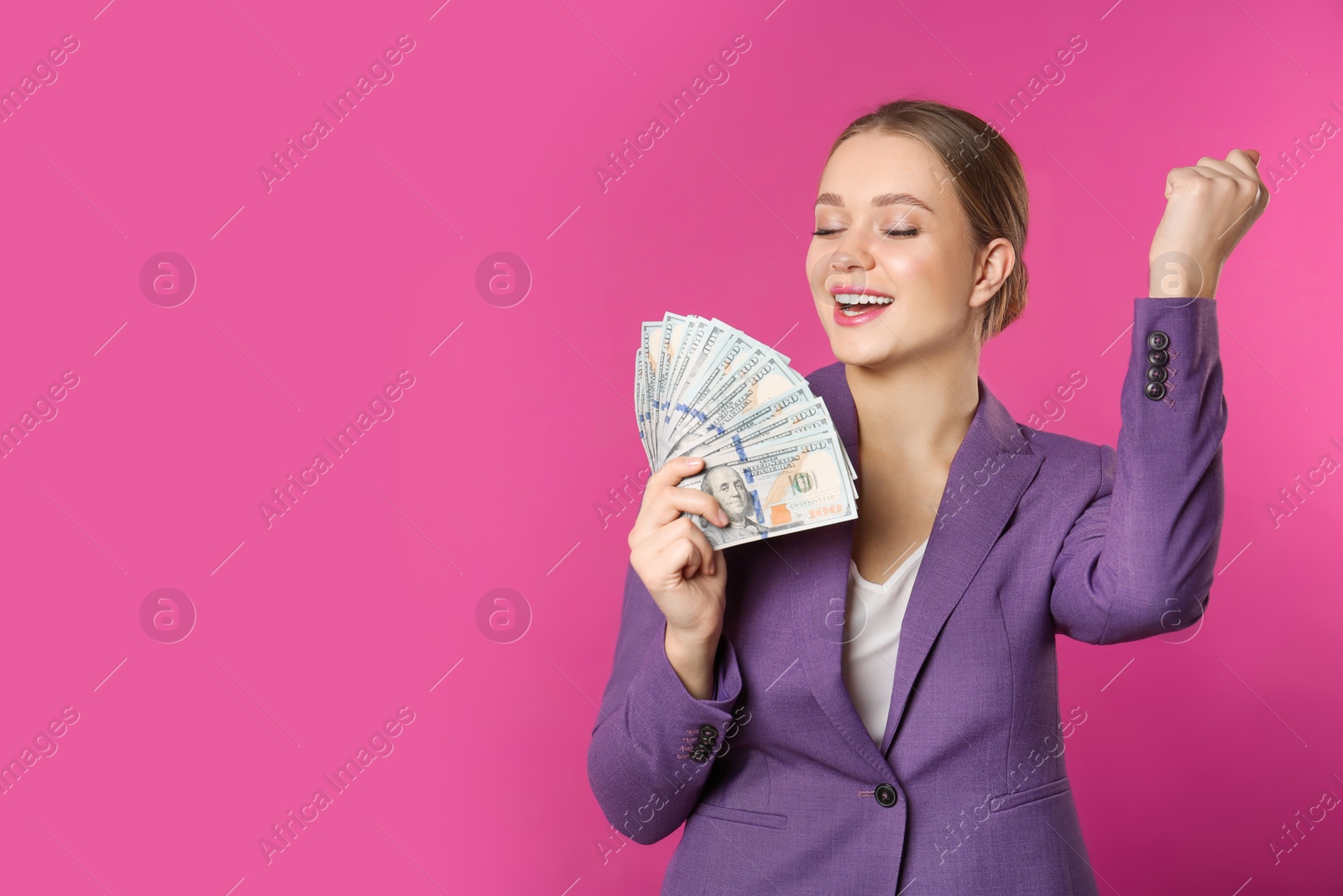 Photo of Portrait of happy young businesswoman with money on color background. Space for text