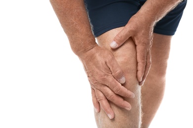 Senior man having knee problems on white background, closeup