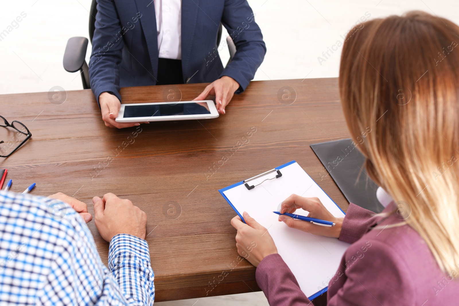 Photo of Human resources manager conducting job interview with applicants in office