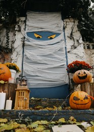 Photo of Yard entrance decorated for traditional Halloween celebration, low angle view