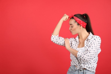 Photo of Strong woman as symbol of girl power on red background, space for text. 8 March concept