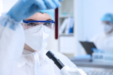 Scientist working with sample in test tube in laboratory